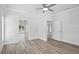 Bright bedroom with ceiling fan, neutral walls, and attractive wood look flooring at 718 Desert Hills Way, Sun City Center, FL 33573