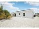 Side view of the property, highlighting the rock landscaping and windows for natural light at 718 Desert Hills Way, Sun City Center, FL 33573