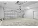 Spacious garage with a clean, concrete floor and a mounted garage door opener at 718 Desert Hills Way, Sun City Center, FL 33573