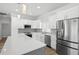 Bright, newly remodeled kitchen featuring stainless steel appliances, quartz counters, and gray backsplash at 718 Desert Hills Way, Sun City Center, FL 33573