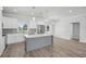 Modern kitchen features white cabinets, stainless steel appliances, and large island with sleek countertops at 718 Desert Hills Way, Sun City Center, FL 33573