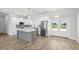 Beautiful kitchen with stainless steel appliances, white cabinetry, and an island, with a dining area nearby at 718 Desert Hills Way, Sun City Center, FL 33573