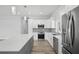 Bright, newly remodeled kitchen featuring stainless steel appliances, quartz counters, and gray backsplash at 718 Desert Hills Way, Sun City Center, FL 33573