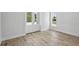 Light and airy room featuring new wood flooring and access to the outside at 718 Desert Hills Way, Sun City Center, FL 33573