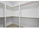 Spacious walk-in closet featuring bright lighting and open shelving at 718 Desert Hills Way, Sun City Center, FL 33573