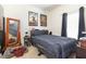 Bedroom featuring a bed, mirror, and posters adorning the walls at 7603 Wood Violet Dr # 2, Gibsonton, FL 33534