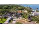 Aerial view of a home with lush landscaping near a waterfront community, with clear blue skies at 8296 33Rd N Ave, St Petersburg, FL 33710