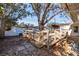 Wooden deck with railing and mature trees provide a private outdoor space in this backyard at 8296 33Rd N Ave, St Petersburg, FL 33710
