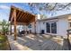 Backyard wood deck with a pergola, table and chairs, and lush landscaping at 8296 33Rd N Ave, St Petersburg, FL 33710