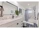Updated bathroom with marble countertop, matte black faucet, framed mirror, and shower with curtain at 8296 33Rd N Ave, St Petersburg, FL 33710