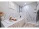 Bright bathroom featuring a soaking tub, marble tiling, and a glass-enclosed shower stall at 8296 33Rd N Ave, St Petersburg, FL 33710