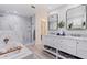 Elegant bathroom featuring a double vanity, modern mirrors, soaking tub, and a luxurious walk-in shower at 8296 33Rd N Ave, St Petersburg, FL 33710