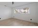 Simple bedroom features a large window for lots of natural light, and a light wood floor at 8296 33Rd N Ave, St Petersburg, FL 33710