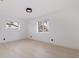 Bright bedroom featuring a light wood floor, two windows for lots of natural light, and white walls at 8296 33Rd N Ave, St Petersburg, FL 33710