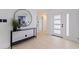 Bright and modern foyer features a stylish console table with round mirror and a frosted glass front door at 8296 33Rd N Ave, St Petersburg, FL 33710