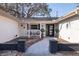 Inviting front porch with decorative tile walkway, modern black door, and cozy seating area at 8296 33Rd N Ave, St Petersburg, FL 33710
