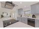 Well-appointed kitchen features a large island cooktop, modern cabinetry, and stainless steel appliances at 8296 33Rd N Ave, St Petersburg, FL 33710