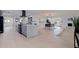 Open-concept kitchen and dining room featuring a large island, modern appliances, and a stylish dining set at 8296 33Rd N Ave, St Petersburg, FL 33710