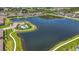 Aerial view showcasing the pond, community pool, and walking path in a residential area at 841 Royal Empress Dr, Ruskin, FL 33570