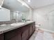 Stylish bathroom featuring dual sinks, granite counters, and tiled floors at 841 Royal Empress Dr, Ruskin, FL 33570