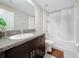 Bathroom with a large mirror, updated vanity with dark wood cabinets, shower-tub combination, and tiled floors at 841 Royal Empress Dr, Ruskin, FL 33570