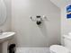 Cozy half bath with a pedestal sink, toilet, and modern decor at 841 Royal Empress Dr, Ruskin, FL 33570