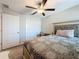 Bedroom with a large bed, double door closet, ceiling fan, and neutral carpet with decor at 841 Royal Empress Dr, Ruskin, FL 33570