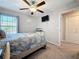 Bedroom featuring a ceiling fan, modern decor, natural light, and neutral colored walls and carpet at 841 Royal Empress Dr, Ruskin, FL 33570