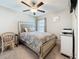 Bedroom with a ceiling fan, large bed with decorative bedspread and a comfortable chair near a small desk at 841 Royal Empress Dr, Ruskin, FL 33570