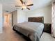 Bedroom boasts a ceiling fan, decorative curtains, plush carpeting, and an adjacent room with ample natural light at 841 Royal Empress Dr, Ruskin, FL 33570