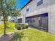 Exterior view of the back of the home with a covered patio and green lawn at 841 Royal Empress Dr, Ruskin, FL 33570