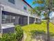 Exterior shot of home with covered patios and a green lawn at 841 Royal Empress Dr, Ruskin, FL 33570