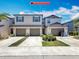 Exterior shot of new townhomes featuring three garage doors and well-maintained landscaping at 841 Royal Empress Dr, Ruskin, FL 33570