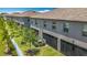Rear exterior view of the home with a covered patio and green lawn at 841 Royal Empress Dr, Ruskin, FL 33570