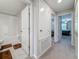 Hallway leads to a bathroom, linen closet, and a bedroom, all featuring modern doors and carpet at 841 Royal Empress Dr, Ruskin, FL 33570