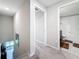 Upstairs hallway with neutral carpet leading to a well-lit bathroom at 841 Royal Empress Dr, Ruskin, FL 33570