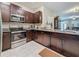 Contemporary kitchen with stainless steel appliances, granite countertops, and sleek cabinetry at 841 Royal Empress Dr, Ruskin, FL 33570