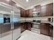 Modern kitchen featuring stainless steel appliances, dark wood cabinets and granite countertops at 841 Royal Empress Dr, Ruskin, FL 33570