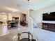 Bright open-concept living space showcases a modern sectional, dining area, and staircase access at 841 Royal Empress Dr, Ruskin, FL 33570