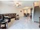 Open-concept living space featuring a modern sectional, dining area, and staircase access at 841 Royal Empress Dr, Ruskin, FL 33570