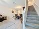 Bright living room featuring tile floors, a dining area, and staircase to the second floor at 841 Royal Empress Dr, Ruskin, FL 33570