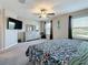 Large main bedroom featuring two windows, ceiling fan, and ensuite bath at 841 Royal Empress Dr, Ruskin, FL 33570