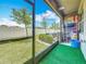 Relax on the screened patio with a view of the green lawn and fenced yard at 841 Royal Empress Dr, Ruskin, FL 33570