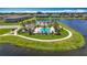 Aerial view of community pool surrounded by a walking path, pond, and lush green space at 841 Royal Empress Dr, Ruskin, FL 33570