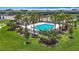 Community pool featuring lounge chairs, umbrellas, and lush landscaping on a sunny day at 841 Royal Empress Dr, Ruskin, FL 33570