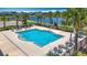 Enjoy the community pool with lounge chairs and palm trees overlooking the water at 841 Royal Empress Dr, Ruskin, FL 33570