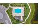 Aerial view of community pool, amenity center, and walking path near a pond at 841 Royal Empress Dr, Ruskin, FL 33570