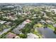 Scenic aerial view showcasing the neighborhood's tree coverage, lakes and residential housing at 9075 Waterash N Ln, Pinellas Park, FL 33782