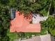 Aerial view of home with red tile roof, screened-in pool and landscaped driveway at 9075 Waterash N Ln, Pinellas Park, FL 33782