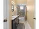 Cozy bathroom with decorative tile accent, vanity, and well-lit mirror at 9075 Waterash N Ln, Pinellas Park, FL 33782